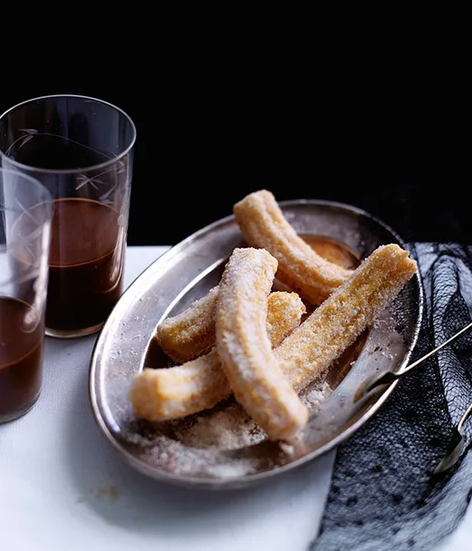 Orange-scented churros with spiked hot chocolate