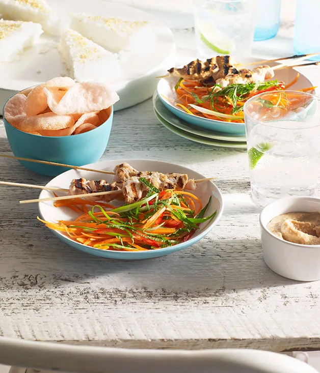 Chicken satay with pressed rice, peanut sauce and carrot salad