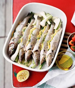 Whole whiting roasted with tomato, lemon and young garlic