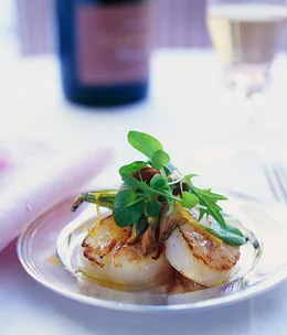 Seared scallops with shaved zucchini flowers