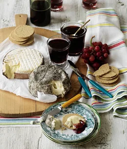 Cheese board with grape jelly and oat biscuits