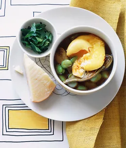 Broad bean and artichoke hotpot with saffron eggs