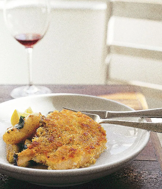 Crumbed pork cutlet with sautéed apples, potatoes and sage