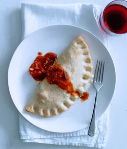 Three-cheese calzone with tomato-chilli sugo