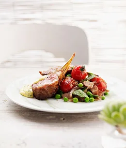 Roast rack of lamb with pancetta, summer vegetables and mint bearnaise