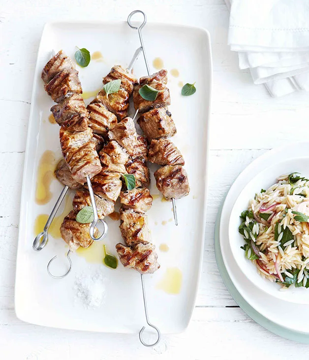 Grilled pork neck and oregano skewers with orzo salad