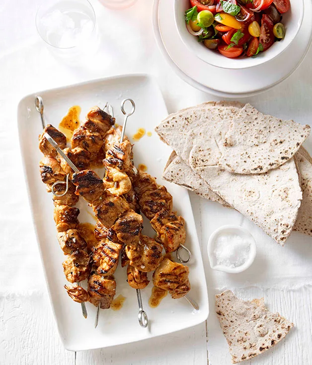 Portuguese chicken skewers with tomato salad and flatbread