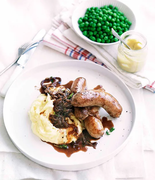 Onion-braised sausages with Paris mash | Gourmet Traveller