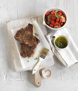 Char-grilled beef T-bone with crushed tomato and bread salad