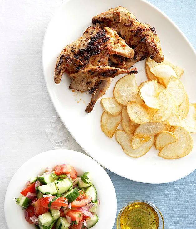 Piri piri quail with chips and tomato and cucumber salad