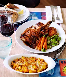 Roast chicken with confit garlic, herbs, carrots and radishes