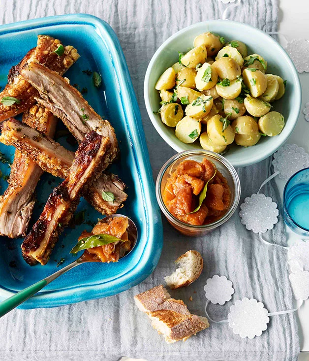 Roast pork belly with peach relish and potato and parsley salad