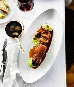 Braised stuffed pig's trotters with cabbage, shallots and potato purée