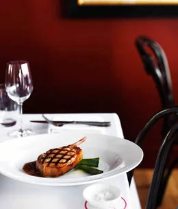 Peppered pork cutlets with Calvados apple purée and grilled leeks