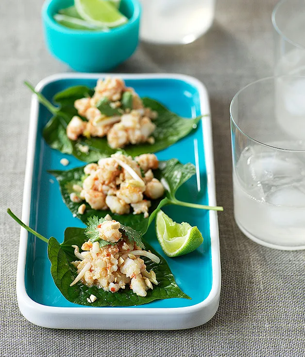 Betel leaves topped with prawns and galangal