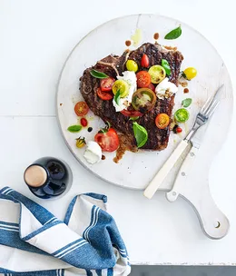 Barbecued T-bones with tomato, mozzarella and basil