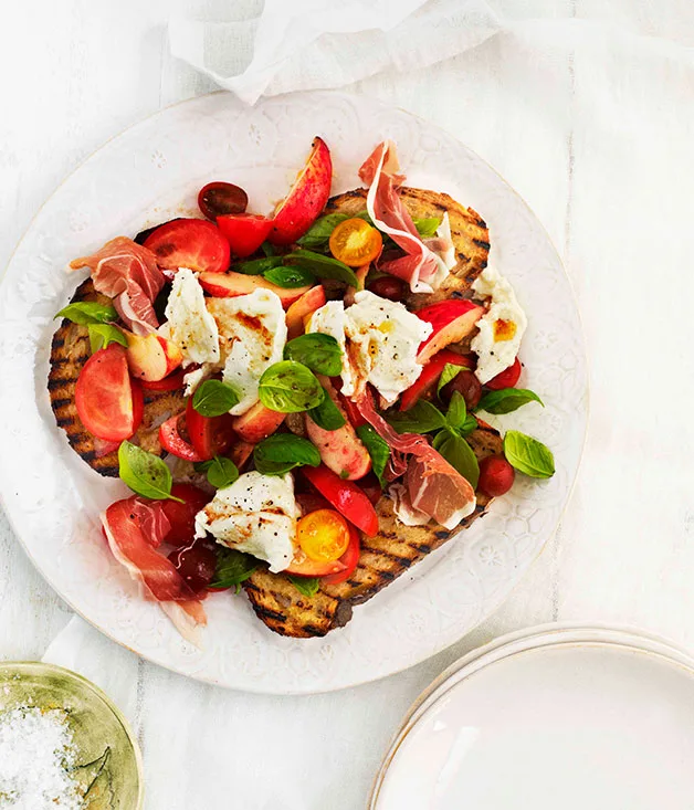 Tomato, prosciutto, peach, basil and mozzarella salad on bruschetta