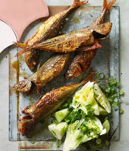 Yellowtail scad fish-fry with cucumber and iceberg salad