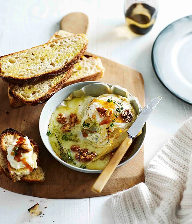 Honey-baked triple cream with walnuts and crostini