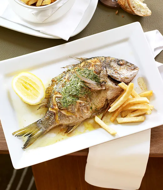 Whole sea bream with herb butter