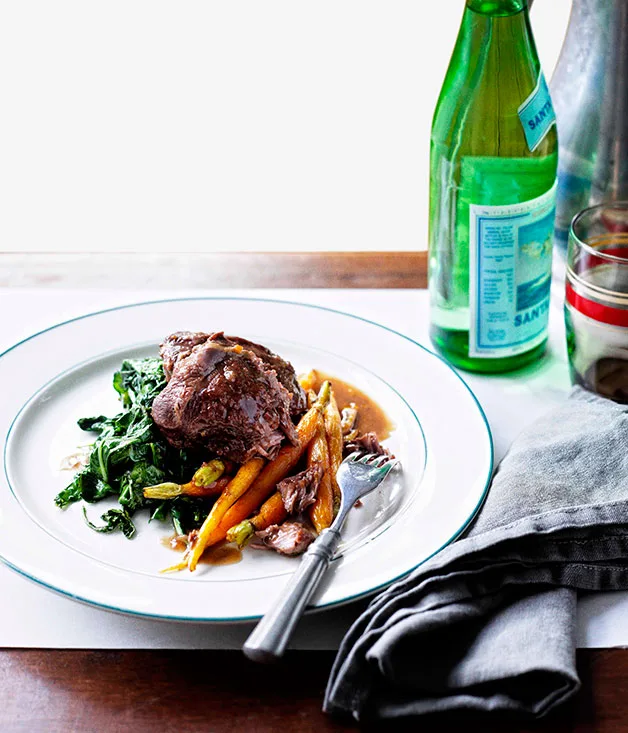 Braised beef cheeks with baby carrots and cavolo nero