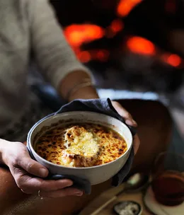 Onion and bacon soup with mustard and cheese crust