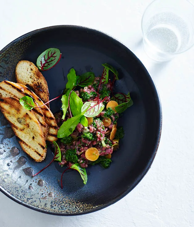 Raw flank steak, pickled carrots and salsa verde