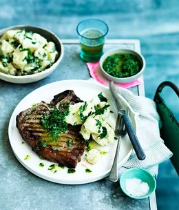 Barbecued T-bones with rough rocket salsa verde and crushed potato salad