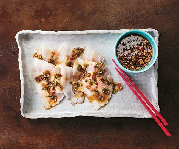 Slices of poached pork belly served with a spicey dipping sauce