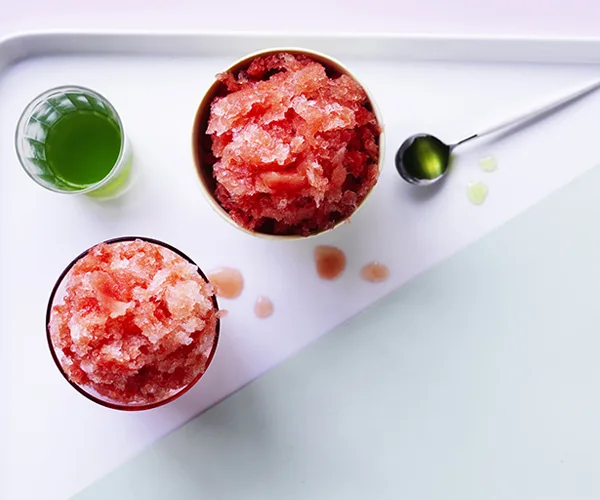 Watermelon and basil make an unexpectedly delicious combination - here in the form of a watermelon shaved ice paired with a basil-infused sugar syrup. Begin this recipe a day ahead to freeze the watermelon ice.