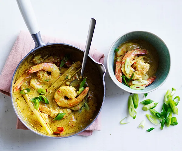 one-pot Prawn curry in silver pan showing yellow curry, prawns and vegetables