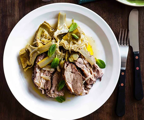 Slow-roasted lamb with sautéed artichokes and mint