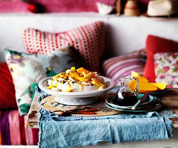 Golden pavlova with mango yoghurt and tropical fruits