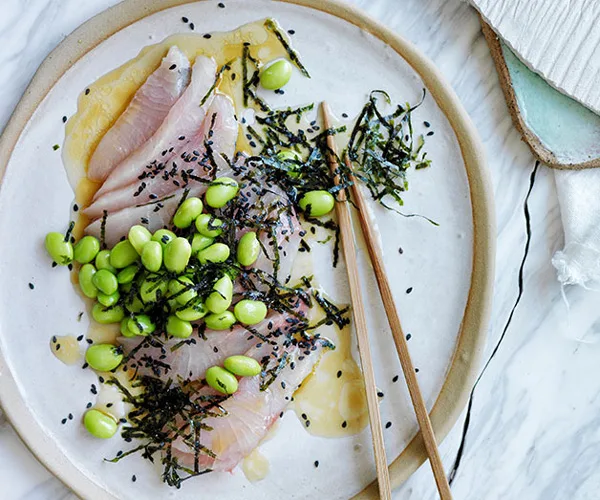 Sashimi of mulloway with a sesame-citrus dressing, edamame and seaweed