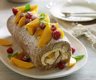 Ginger sponge roulade with mango-ripple cream