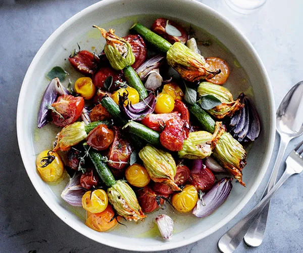 Roast stuffed zucchini flowers with tomato and oregano