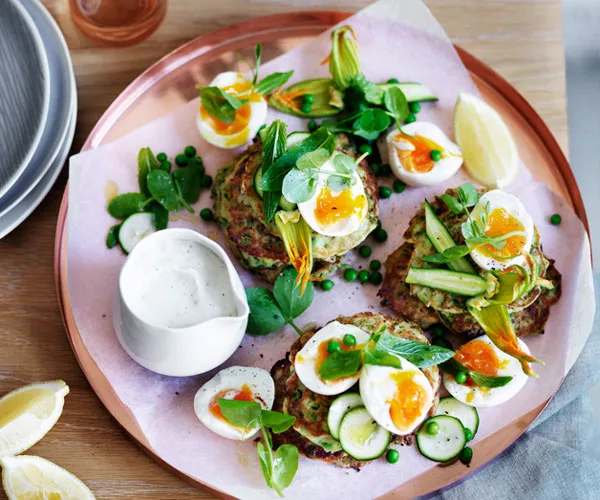 Pea, zucchini and mint fritters with eggs and feta sauce