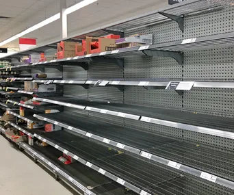 Empty supermarket shelves as a result of panic-buying triggered by COVID-19 fears.