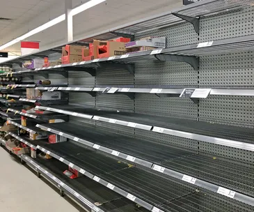 Empty supermarket shelves as a result of panic-buying triggered by COVID-19 fears.