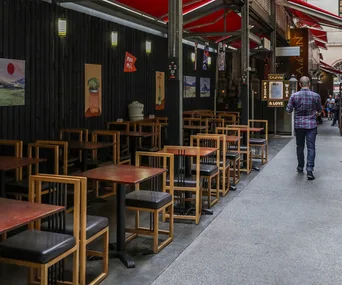 Unoccupied dining tables and chairs at a restaurant in the Melbourne CBD.
