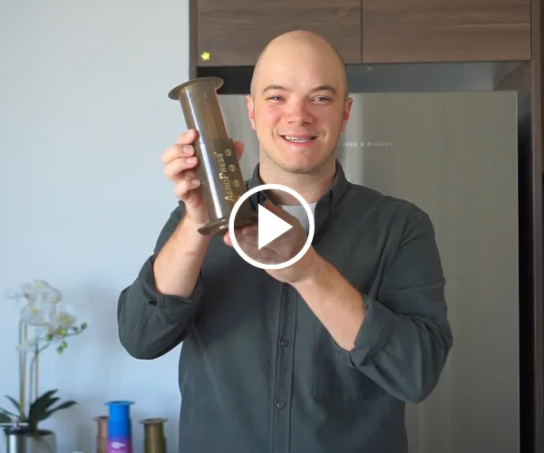 Barista James Perry of James Perry Coffee holding an Aeropress.