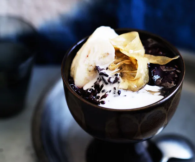 Sticky black rice with coconut cream, ginger syrup and banana