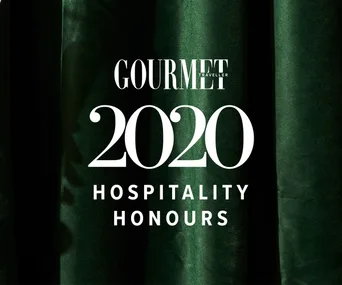 A emerald-green velvet background, with white text overlaid that reads Gourmet Traveller 2020 Hospitality Honours