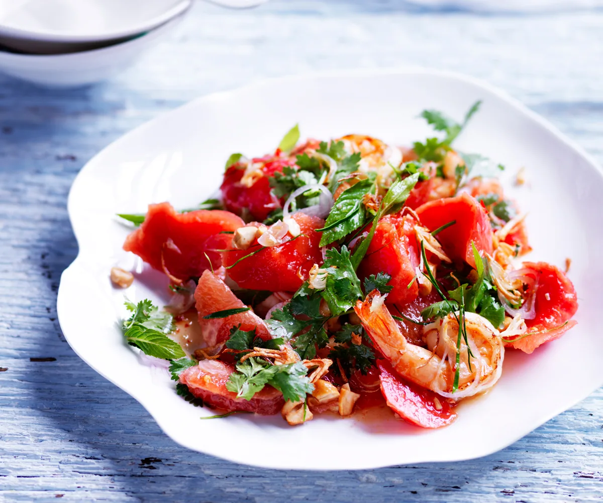 Sweet and sour watermelon salad with pink grapefruit and prawns