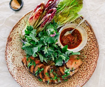 Amy Chanta and Palisa Anderson’s kor mhu yaang with nahm jim jaew (grilled pork neck with smoked chilli sauce)