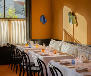 A sun-washed apricot-coloured dining room. 