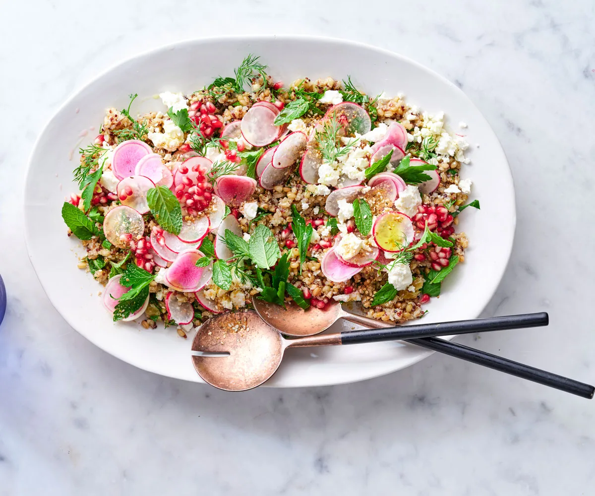 White bowl with salad of chunky chopped beetroot, shredded parsley and brow lentils, with a bronze fork.