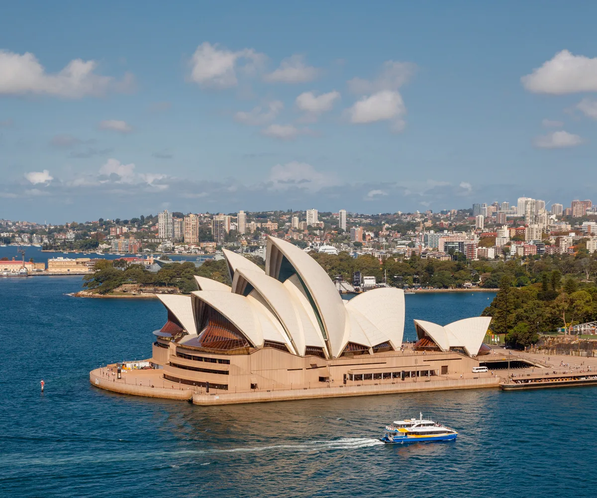 Photo of Sydney Opera House and Sydney Habour with a ferry sailing past the Opera House