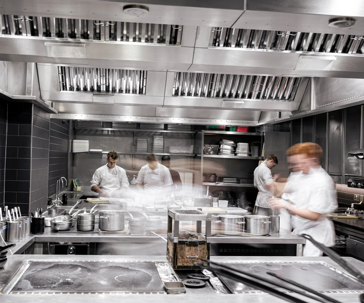 Four chefs working in the kitchen at Restaurant Gordon Ramsay in London, UK