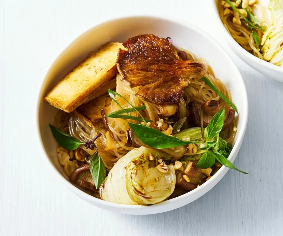 Bowl of stir-fried sweet potato noodles with tofu